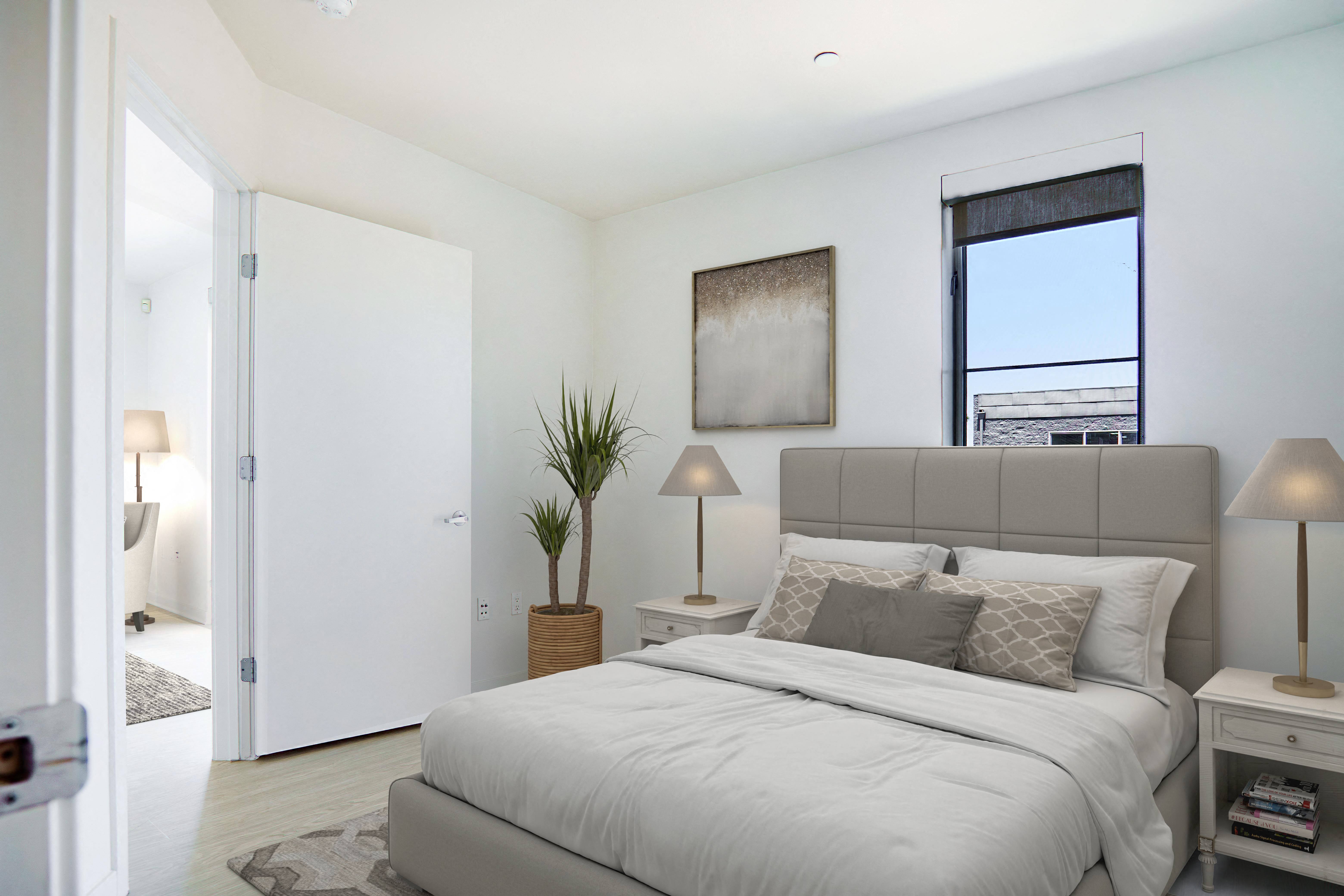 a living room with white walls and a wooden table and chairs